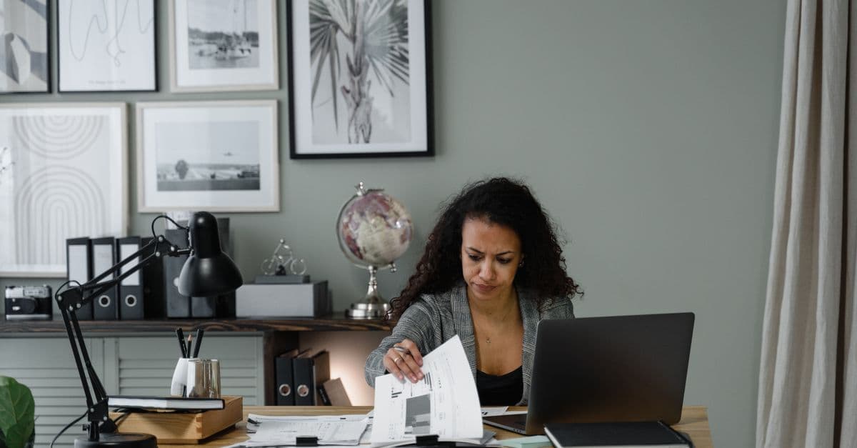 A leasing staff member reviews paperwork at a desk.