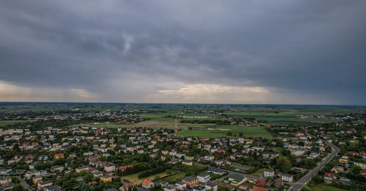Aerial view of a small town surrounded by farmland, the kind of low-rise rural community USDA Rural Development properties serve.